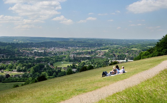 BMRP8P A group of people enjoying the view of Dorking from Box Hill in Surrey, England.